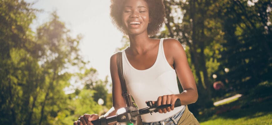 Portrait,Of,Cheerful,Cheery,Glad,Wavy-haired,Girl,Walking,Riding,Kick