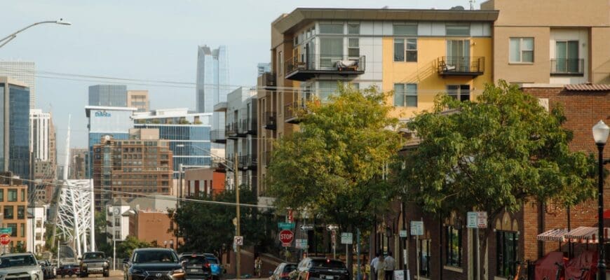 External view of the neighborhood surrounding Line 28 at Lohi with cross streets, the property exterior, and Denver city views in the background